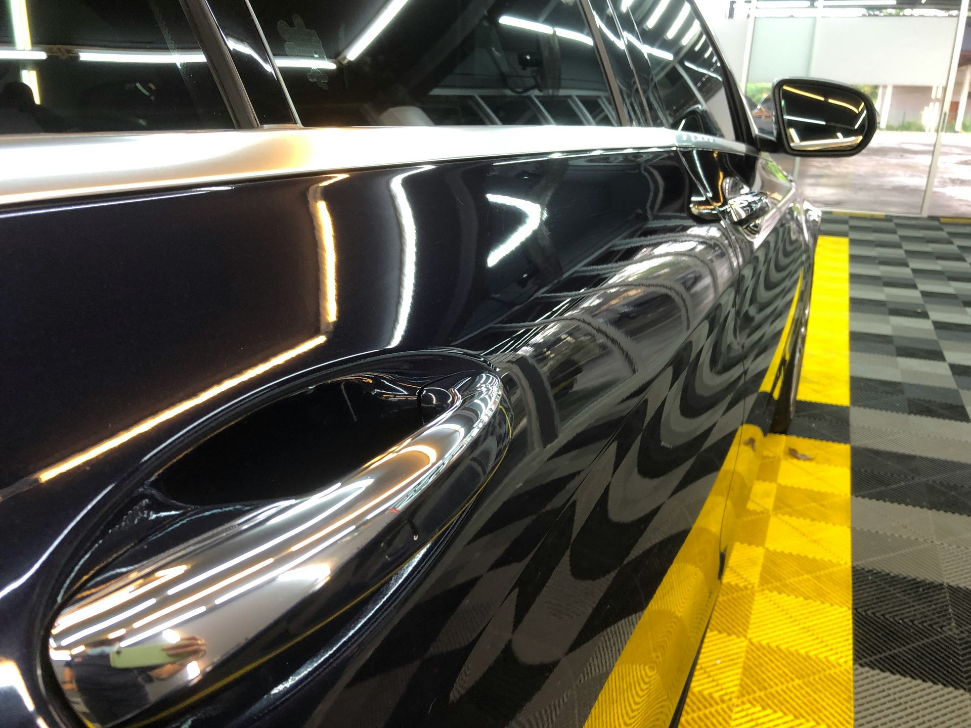 a car parked in a garage with a checkered floor